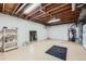 Unfinished basement with painted walls, exposed ceiling, storage shelves, and utility components at 6727 S Race St, Centennial, CO 80122