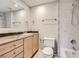 Bathroom featuring a vanity with cabinets, toilet, and shower-tub combo at 6727 S Race St, Centennial, CO 80122