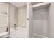 Bathroom featuring a shower-tub combo and neutral tile at 6727 S Race St, Centennial, CO 80122