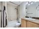 A well-lit bathroom featuring a tiled shower, vanity with sink, and modern fixtures at 6727 S Race St, Centennial, CO 80122