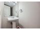 Powder room featuring pedestal sink and a neutral color palette at 6727 S Race St, Centennial, CO 80122