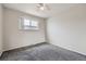 A cozy bedroom featuring neutral walls, carpet, and a window offering natural light at 6727 S Race St, Centennial, CO 80122