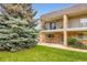 Townhouse exterior with lush green lawn and mature trees creates a welcoming scene at 6727 S Race St, Centennial, CO 80122