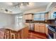 Bright kitchen featuring a central island and stainless steel appliances at 6727 S Race St, Centennial, CO 80122