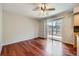 Open-concept with hardwood floors, sliding glass door, and ceiling fan at 6727 S Race St, Centennial, CO 80122