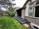 Exterior of home with a stone patio and a well-manicured lawn at 6875 Northstar Ct, Castle Rock, CO 80108