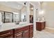 Spacious bathroom featuring dual vanities, large mirror, and access to a walk-in closet at 6875 Northstar Ct, Castle Rock, CO 80108