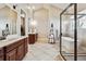 Bright bathroom with dual sinks, soaking tub, glass enclosed shower, and access to walk-in closet at 6875 Northstar Ct, Castle Rock, CO 80108