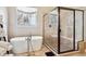 Modern bathroom featuring a soaking tub, glass enclosed shower, and large window at 6875 Northstar Ct, Castle Rock, CO 80108