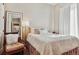 Bright bedroom with a large window, mirror, and comfortable seating at 6875 Northstar Ct, Castle Rock, CO 80108
