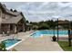 Community pool and hot tub are adjacent to a well maintained building and surrounded by chairs at 6875 Northstar Ct, Castle Rock, CO 80108