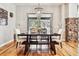 Charming dining room with hardwood floors, a chandelier, and views of the natural landscape outside at 6875 Northstar Ct, Castle Rock, CO 80108