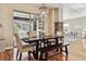 Dining area showcases wood floors, chandelier, and natural light from sliding glass doors with a stone feature wall at 6875 Northstar Ct, Castle Rock, CO 80108