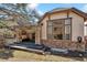 Charming home exterior showcasing stone accents, a covered patio, and professional landscaping at 6875 Northstar Ct, Castle Rock, CO 80108