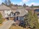 Beautiful home featuring stone accents, a two-car garage, and established trees at 6875 Northstar Ct, Castle Rock, CO 80108