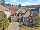 Charming home featuring stone accents, a two-car garage, and mature trees and shrubs at 6875 Northstar Ct, Castle Rock, CO 80108