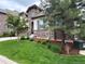 Inviting home with lush landscaping and a stone-accented exterior, complete with a two-car garage and a well-kept lawn at 6875 Northstar Ct, Castle Rock, CO 80108