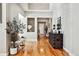 Inviting foyer with hardwood floors, decorative plant, and view of the living spaces at 6875 Northstar Ct, Castle Rock, CO 80108