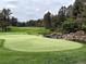 The beautiful green of a local golf course is visible over a scenic pond at 6875 Northstar Ct, Castle Rock, CO 80108