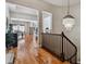 Bright hallway leading to open-concept living areas with hardwood flooring and stylish chandelier at 6875 Northstar Ct, Castle Rock, CO 80108