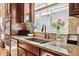 A close-up of kitchen featuring granite countertops, stainless steel appliances, and stylish backsplash at 6875 Northstar Ct, Castle Rock, CO 80108