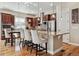 Open kitchen with granite countertops, stainless steel appliances, dark wood cabinets, and barstool seating at the island at 6875 Northstar Ct, Castle Rock, CO 80108