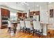 A well-appointed kitchen featuring a center island, granite countertops, stainless steel appliances, and hardwood floors at 6875 Northstar Ct, Castle Rock, CO 80108