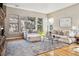 Bright and inviting living room with large windows that look out to a beautiful mountainside at 6875 Northstar Ct, Castle Rock, CO 80108