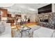 Open concept living area featuring hardwood floors, kitchen island with seating, and a stone fireplace at 6875 Northstar Ct, Castle Rock, CO 80108