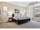 Serene bedroom with neutral tones, natural light, carpet, and an accent wall with rock outcropping outside window at 6875 Northstar Ct, Castle Rock, CO 80108