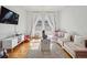 Bright playroom with hardwood floors, white walls, a TV, and a comfortable pink couch at 6875 Northstar Ct, Castle Rock, CO 80108