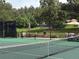 Tennis courts are surrounded by trees and feature covered tables and chairs at 6875 Northstar Ct, Castle Rock, CO 80108