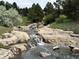Peaceful, natural creek and rock formation with landscaped banks at 6875 Northstar Ct, Castle Rock, CO 80108