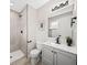 Modern bathroom featuring a step-in shower, updated fixtures, and a stylish vanity with sink at 9120 W 3Rd Pl, Lakewood, CO 80226