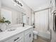 Bright bathroom with a shower-tub, updated fixtures, and a stylish vanity with sink at 9120 W 3Rd Pl, Lakewood, CO 80226