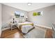 Bright bedroom featuring hardwood floors, neutral walls, and two windows for ample natural light at 9120 W 3Rd Pl, Lakewood, CO 80226