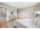 Bright bedroom featuring hardwood floors, neutral walls, and connected bathroom with step-in shower at 9120 W 3Rd Pl, Lakewood, CO 80226