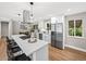 Spacious kitchen with stainless steel refrigerator, white cabinets and eat in island at 9120 W 3Rd Pl, Lakewood, CO 80226