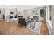 Open-concept living room and kitchen with hardwood floors and modern gray furnishings at 9120 W 3Rd Pl, Lakewood, CO 80226