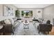Inviting living room featuring modern furnishings, hardwood floors, and large windows at 9120 W 3Rd Pl, Lakewood, CO 80226
