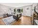 Cozy living room with hardwood floors, modern gray furnishings, and plenty of natural light at 9120 W 3Rd Pl, Lakewood, CO 80226