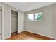 Bright bedroom features hardwood floors, large window, and closet with sliding doors at 8881 Judson St, Westminster, CO 80031
