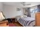 Light-filled bedroom featuring hardwood floors, ceiling fan and a large window at 8881 Judson St, Westminster, CO 80031