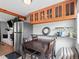 Cozy dining area with stylish wooden cabinets, a modern stainless steel refrigerator, and comfortable seating at 8881 Judson St, Westminster, CO 80031