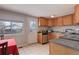 Well-lit kitchen featuring wooden cabinets, modern appliances, and a window with a view of the backyard at 8881 Judson St, Westminster, CO 80031