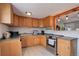 Modern kitchen featuring wooden cabinets, a stainless steel oven, and open layout concept at 8881 Judson St, Westminster, CO 80031