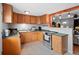 Traditional-style kitchen showcasing ample counter space, tiled floor, and stainless steel appliances at 8881 Judson St, Westminster, CO 80031