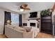 Living room featuring a brick fireplace and large sofa at 8881 Judson St, Westminster, CO 80031