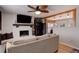 Comfortable living room with a white brick fireplace, open to the kitchen area, and hardwood flooring at 8881 Judson St, Westminster, CO 80031