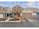 Charming townhome exterior featuring a two-car garage and well-maintained landscaping in a suburban neighborhood at 9118 W 50Th Ln # 5, Arvada, CO 80002